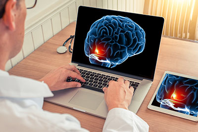 A doctor examines a scan of a brain injury victim.