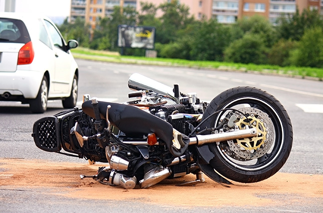 motorcycle laying in the middle of the street