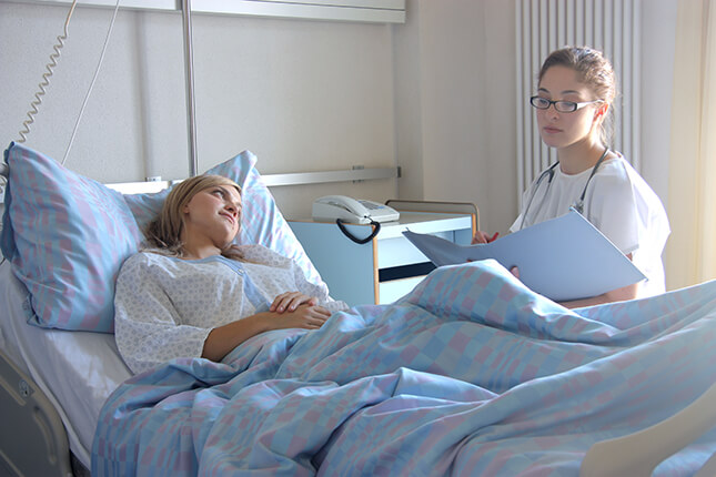 Personal injury victim in a hospital bed being treated by a doctor